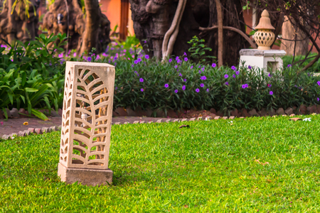 Carved stone lamp decoration in cozy home garden on summer.の写真素材