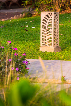Carved stone lamp decoration in cozy home garden on summer.の写真素材