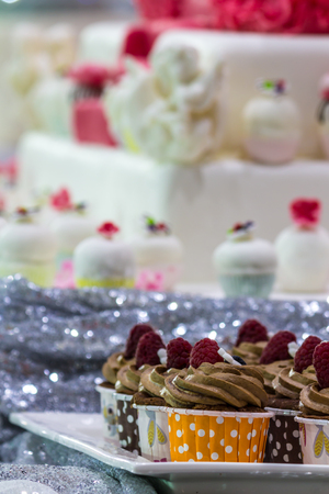 Homemade sweet beauty flower and topping decoration on wedding cupcake.の写真素材