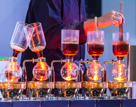 Syphon Coffee or Vacuum Coffee is full immersion tasteful, Blended smell and taste of roasted coffee with direct contact boiled water and show Mix coffee beans into boiling water and stir 10 time.の写真素材