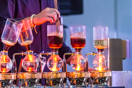 Syphon Coffee or Vacuum Coffee is full immersion tasteful, Blended smell and taste of roasted coffee with direct contact boiled water and show Mix coffee beans into boiling water and stir 10 time.の写真素材