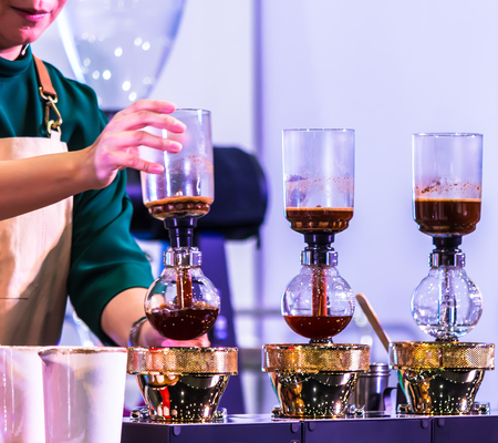 Syphon Coffee or Vacuum Coffee is full immersion tasteful, Blended smell and taste of roasted coffee with direct contact boiled water and show Mix coffee beans into boiling water and stir 10 time.の写真素材