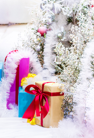 Every december cool and white christmas tree decoration with colourful bauble, mask, snow man, giftbox.の写真素材
