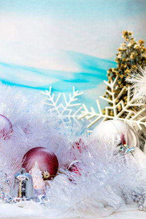 Every december cool and white christmas tree decoration with colourful bauble, mask, snow man, giftbox.の写真素材