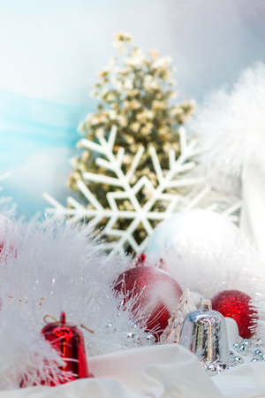 Every december cool and white christmas tree decoration with colourful bauble, mask, snow man, giftbox.の写真素材