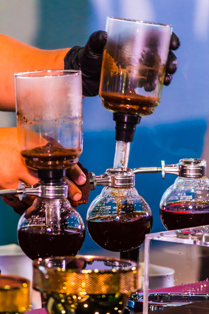 Syphon Coffee or Vacuum Coffee is full immersion tasteful, this picture show mix coffee beans into boiling water and stir 10 time.の写真素材
