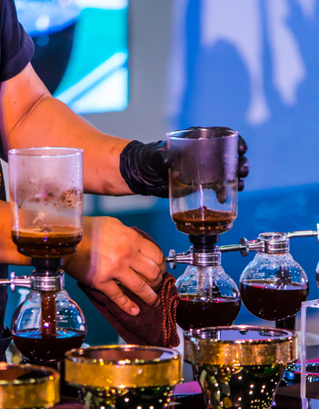 Syphon Coffee or Vacuum Coffee is full immersion tasteful, this picture show mix coffee beans into boiling water and stir 10 time.の写真素材