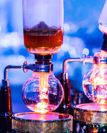 Syphon Coffee or Vacuum Coffee is full immersion tasteful, this picture show mix coffee beans into boiling water and stir 10 time.の写真素材
