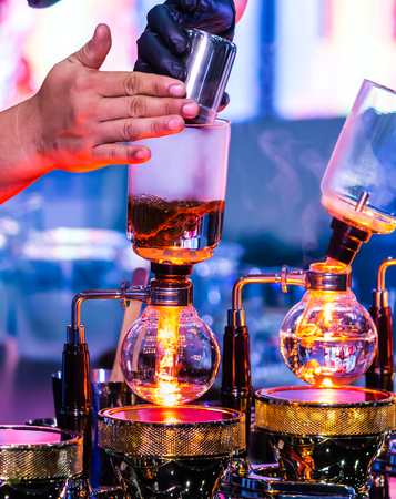 Syphon Coffee or Vacuum Coffee is full immersion tasteful, this picture show mix coffee beans into boiling water and stir 10 time.の写真素材
