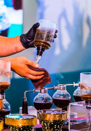 Syphon Coffee or Vacuum Coffee is full immersion tasteful, this picture show mix coffee beans into boiling water and stir 10 time.の写真素材