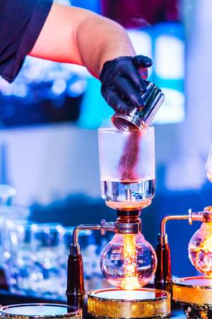 Syphon Coffee or Vacuum Coffee is full immersion tasteful, this picture show mix coffee beans into boiling water and stir 10 time.の写真素材