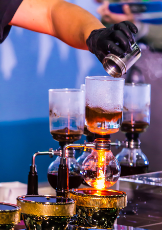 Syphon Coffee or Vacuum Coffee is full immersion tasteful, this picture show mix coffee beans into boiling water and stir 10 time.の写真素材