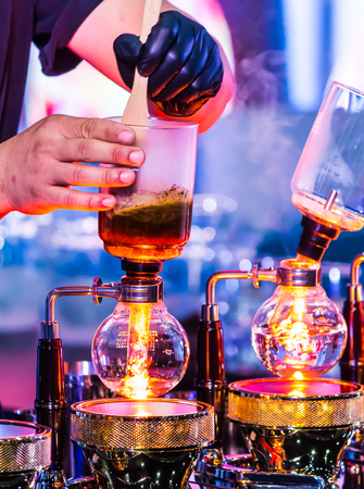Syphon Coffee or Vacuum Coffee is full immersion tasteful, this picture show mix coffee beans into boiling water and stir 10 time.の写真素材