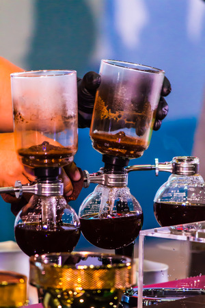 Syphon Coffee or Vacuum Coffee is full immersion tasteful, this picture show mix coffee beans into boiling water and stir 10 time.の写真素材