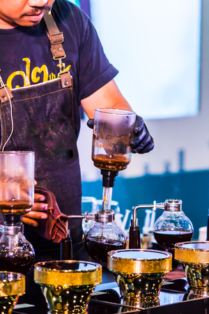 Syphon Coffee or Vacuum Coffee is full immersion tasteful, this picture show mix coffee beans into boiling water and stir 10 time.の写真素材