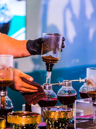 Syphon Coffee or Vacuum Coffee is full immersion tasteful, this picture show mix coffee beans into boiling water and stir 10 time.の写真素材