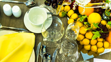 Topview party dinner table setting with tableware and silverware and glasses set and Candlestick and flower in restaurant.の写真素材