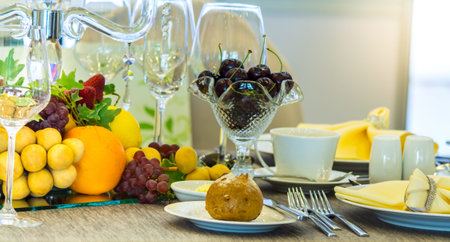 Party dinner table setting with tableware and silverware and glasses set and Candlestick and flower...