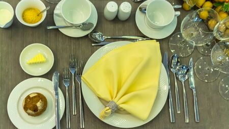 Topview party dinner table setting with tableware and silverware and glasses set and Candlestick and flower in restaurant.の写真素材