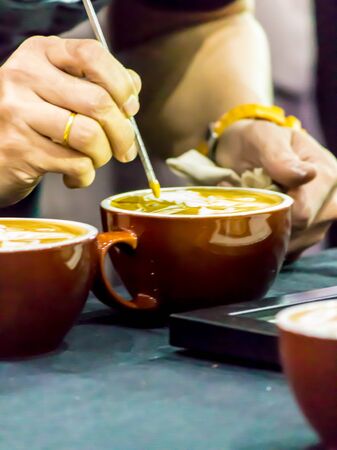 Showcase Barista making Latte art coffee and Barista pouring fresh milk create art pattern on Latte coffe.の写真素材