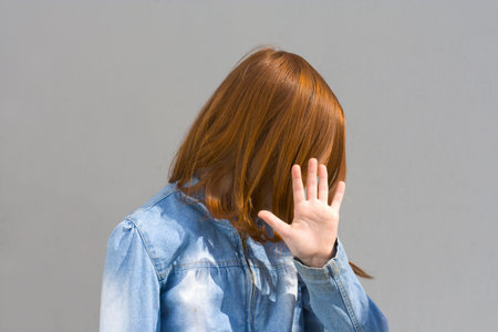 Girl hides her faceの写真素材