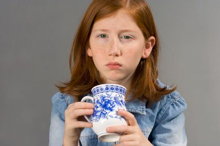 Girl drinking tea trying to awakenの写真素材