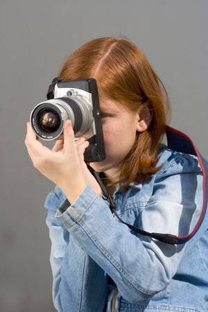 Girl shooting SLR photo cameraの写真素材