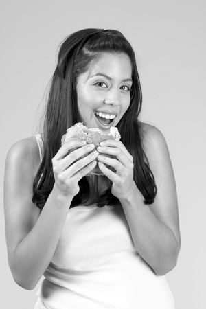Smiling Female eats tasty hamburgerの写真素材