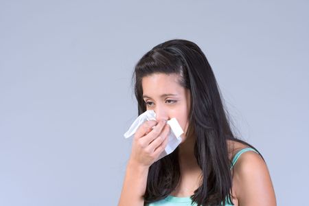 Girl covers her mouth and nose with handkerchiefの写真素材