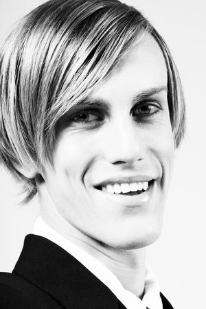 Portrait of young handsome smiling blonde male (BW), 60th styleの写真素材