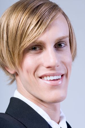 Portrait of young handsome smiling blonde maleの写真素材