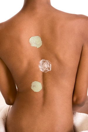 Body care Â¬C African American female torso with three types of skincare product (moisturizer)...
