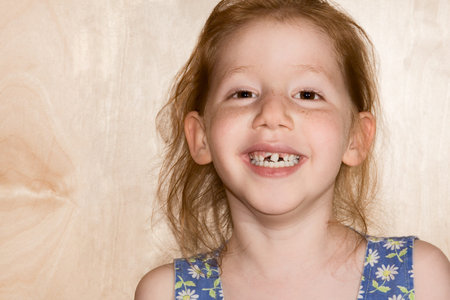 six year old girl funny girl reveals her changing tooth situation. Her deciduous teeth are beginning...