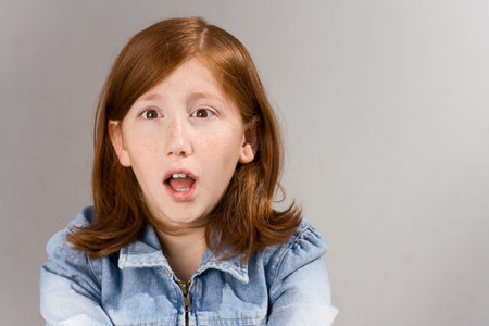 Portrait if young red haired female in sock with open mouthの写真素材