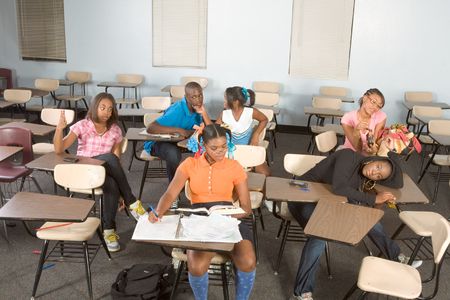 High school classroom with six children, one boy and five girls, making chaosの写真素材