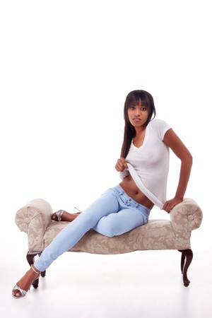 Sensual black ethnic biracial (mix of African-American and Native American ethnicity) woman stripper undressingの写真素材