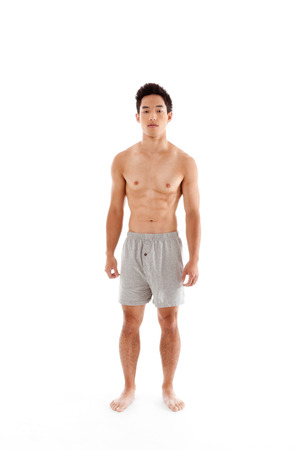 Young seminude Handsome Asian Chinese man in boxers underwearの写真素材