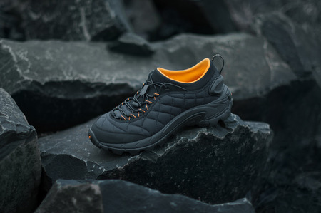 trekking black shoes on the rocksの写真素材