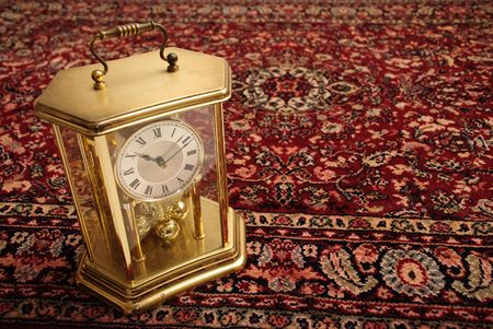 Antique clock on a Persian rugの写真素材