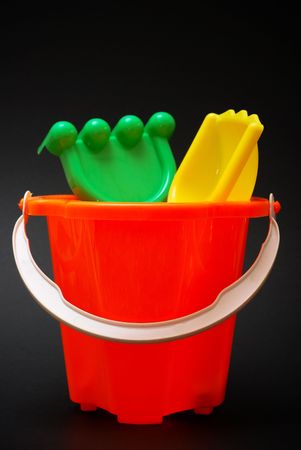 Plastic beach toys on black backgroundの写真素材