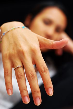 A woman showing her wedding ring to the cameraの写真素材