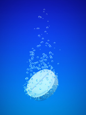 Effervescent tablet with bubbles in blue waterの写真素材