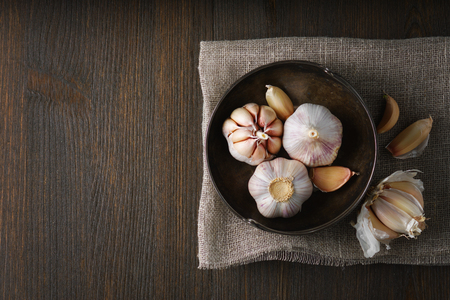 Garlic and garlic cloves in selective focus on dark background.の写真素材