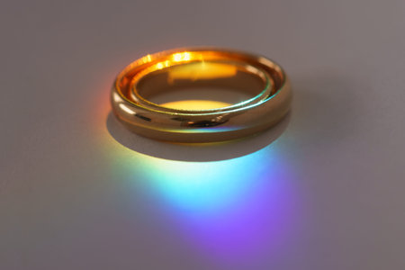Two wedding rings with rainbow light macro.