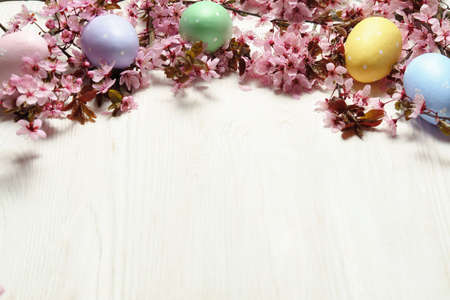 Spring flowers and easter eggs on wooden background.の写真素材