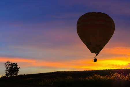 Hot air balloon flying at sunset.の写真素材