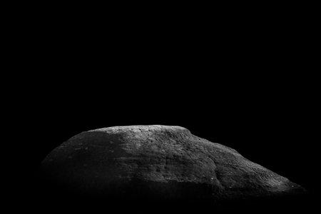 Stone podium on dark black background.
