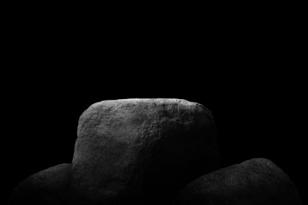 Stone podium on dark black background.の写真素材