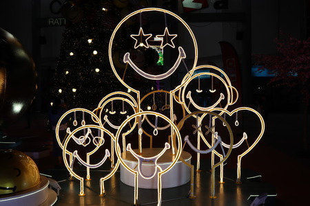 There are many smile faces with the yellow light in Christmas festivalのeditorial素材