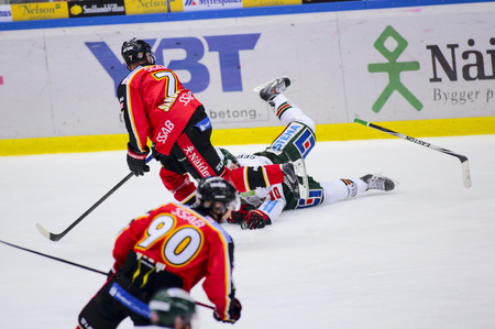 Lulea, Sweden - March 18, 2015. Jan Sandstrm (#7 Lulea Hockey) tackles Mattias Janmark (#10 Frolunda Indians). Swedish Hockey League-game, between Lulea Hockey and Frolunda Indians.のeditorial素材